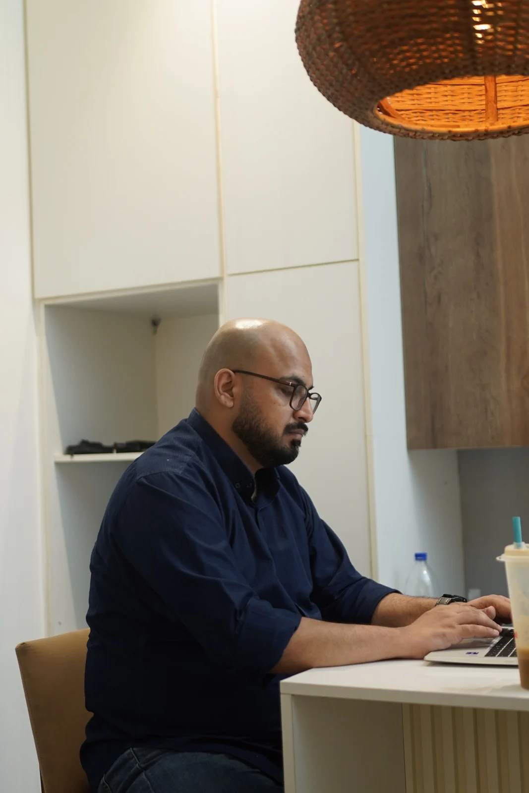 Ali Arshad working on a laptop